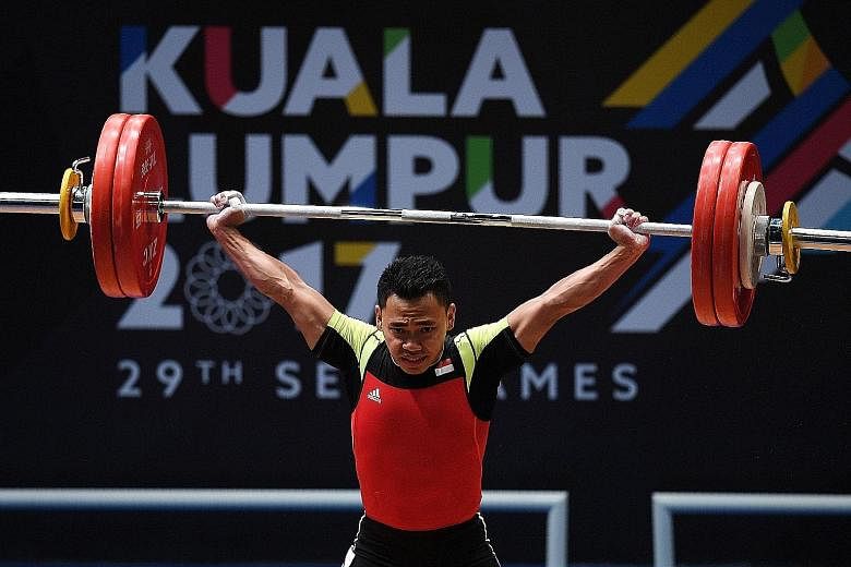 Indonesia's four-time SEA Games weightlifting champion Eko Yuli Irawan (above) showing the strain of competing in the 62kg final yesterday. He finished with the silver medal after a total of 306kg, behind Vietnam's Trinh Van Vinh, who lifted 307kg.