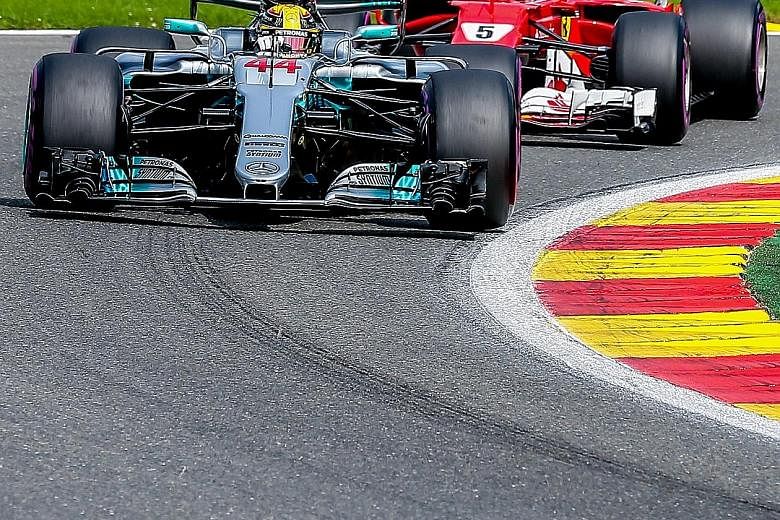 Mercedes' Lewis Hamilton leading the Belgium Grand Prix with Ferrari's Sebastian Vettel snapping at his heels. The Briton's win cut the gap between the two in the drivers' championship to seven points.