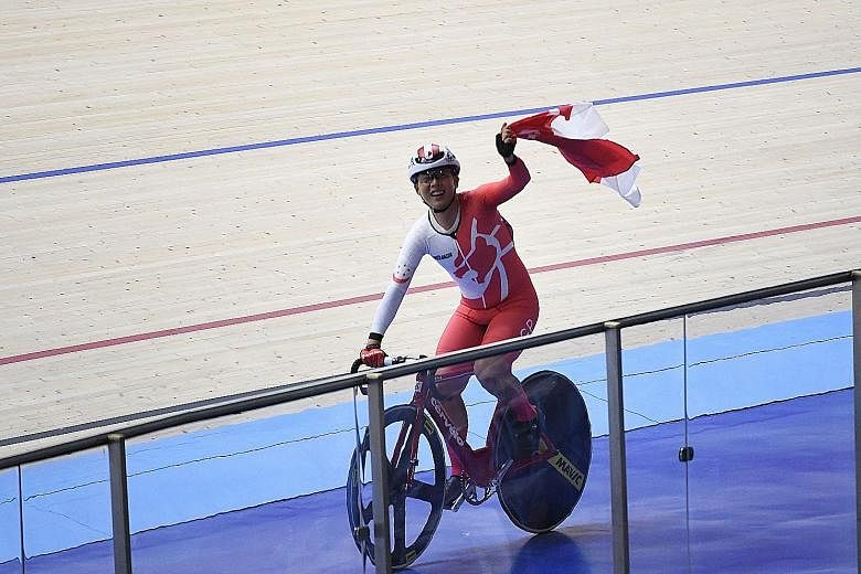 Calvin Sim waving Singapore's flag proudly at the National Velodrome in Nilai after winning the men's omnium race last night. He topped a field of 11 riders.
