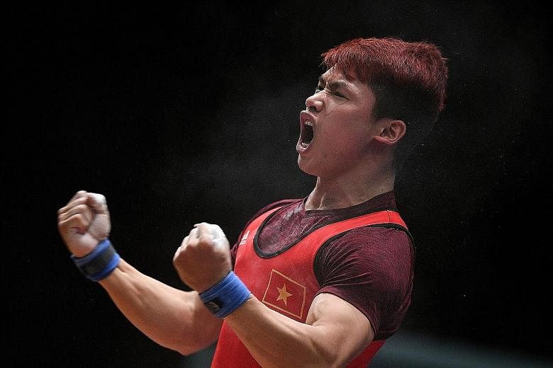 Indonesia's four-time SEA Games weightlifting champion Eko Yuli Irawan (above) showing the strain of competing in the 62kg final yesterday. He finished with the silver medal after a total of 306kg, behind Vietnam's Trinh Van Vinh, who lifted 307kg.
