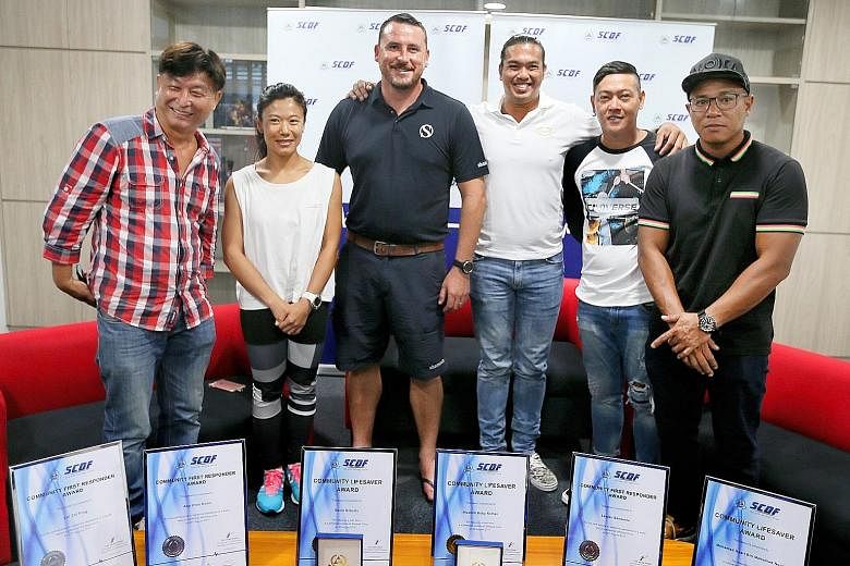 (From left) Mr Ang Chee Boon, Ms Lei Zhi Ping, Mr David Roberts, Mr Nicolich Boby Noman, Mr Leojan Banzuela and Mr Mohammad Hasir Mohammad Yoor were presented with the Community Lifesaver and Community First Responder awards at the Sentosa Fire Stati