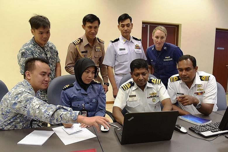 Seacat participants working together to share information and to coordinate responses to maritime threats. The Republic of Singapore Navy's Accompanying Sea Security Team conducting a compliant boarding during an exercise.