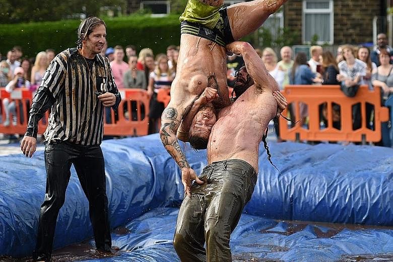 Competitors facing off in the 10th annual World Gravy Wrestling Championships held at a pub in Lancashire in north-west England on Monday. The contestants take part in fancy dress and wrestle in a pool of Lancashire Gravy for two minutes while being 