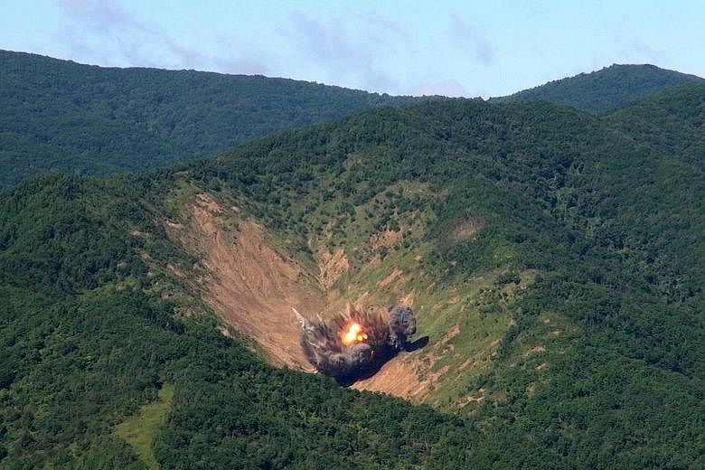 Bombs dropped by South Korean F-15 fighter jets hitting a simulated target in South Korea's eastern province of Gangwon yesterday, hours after North Korea fired a missile that flew over Japan. Officials said the exercise shows that the South can wipe