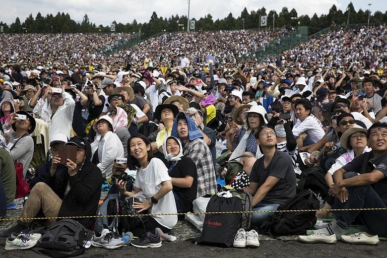 Spectators watching live-fire drills by Japan's Self-Defence Forces in the foothills of Mount Fuji in Gotemba on Sunday.
