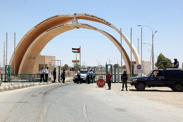 Jordanian security personnel at the Karameh border crossing in this file photo taken on June 25, 2014. The reopening of the post is a sign of increasing stability in the area.