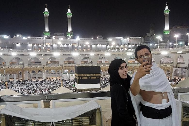 Pilgrims taking a wefie at the Grand Mosque in Mecca yesterday. Over 100,000 security personnel have been mobilised for the haj, to avoid a repeat of the stampede in 2015 in which nearly 2,300 were killed.