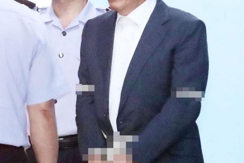 Won Sei Hoon being taken to a detention centre after the Seoul High Court sentenced him to four years in prison. 