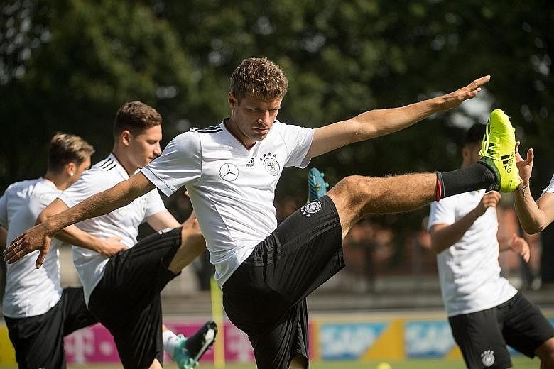 Thomas Muller and his team-mates of the German national team warming up during a training session in Stuttgart on Wednesday, as they prepare to travel to Prague for the World Cup qualifier against the Czech Republic today.