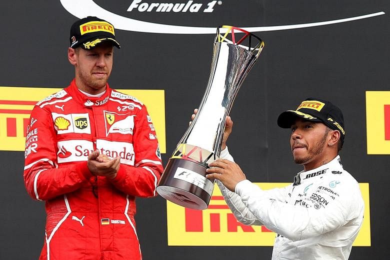 Mercedes' Lewis Hamilton celebrating with the trophy after victory in the Belgian Grand Prix last week as Ferrari's Sebastian Vettel looks on. The Briton will be seeking a record 69th pole at the Italian Grand Prix this weekend and the prospect of ov