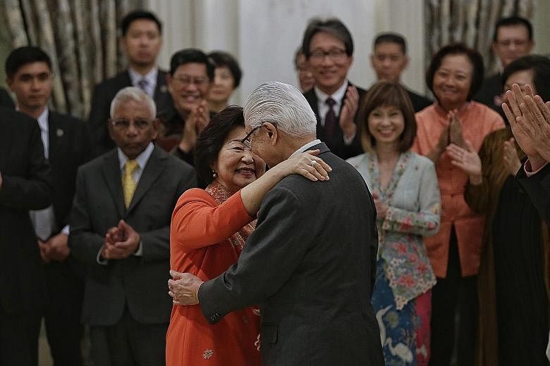 Dr Tony Tan Keng Yam getting a hug from his wife Mary as he stepped down as president at the Istana yesterday. In his speech, PM Lee noted how Mrs Tan was always by her husband's side and would put everyone at ease, while Dr Tan said she brought warm