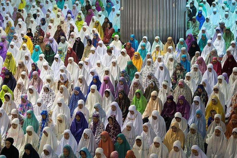 Women attending prayers on the Muslim holiday of Eid Al-Adha at Istiqlal mosque in Jakarta, Indonesia. Also known as the Feast of Sacrifice, which commemorates the prophet Abraham's willingness to sacrifice his son, the holiday marks the end of the a
