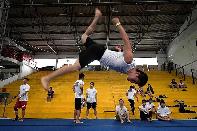 Martial arts instructor Teo Chee Wei, 22, performing a flashkick during the Singapore Tricking Gathering yesterday at the GymKraft gymnasium in Guillemard Road. It was the first such formal gathering here for practitioners of the discipline, which is