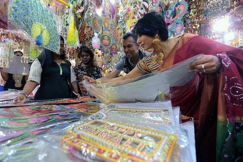 From left: Residents distributing ketupat and other dishes at a community event in Woodlands, a stall selling self-crafted decorations at the Deepavali Festival Village, and Chinatown during Chinese New Year. Singapore's idea of multiculturalism, say