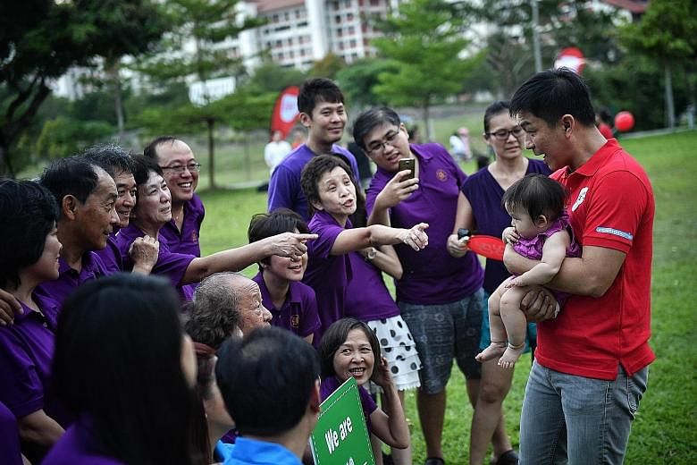 Members of the Teow family with Social and Family Development Minister Tan Chuan-Jin, holding seven-month-old Chloe Sek, at the picnic event yesterday. Chloe is a fourth-generation member of the family.