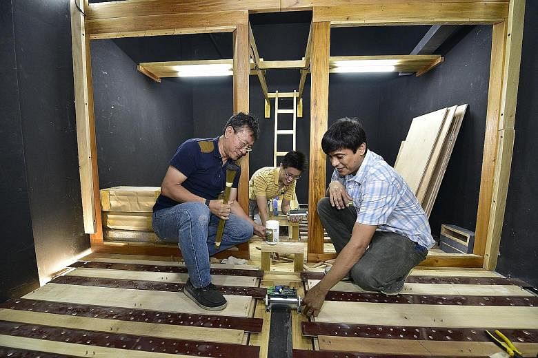 From left: Carillon Technology Singapore director Roster Wu, his son, Mr Ryn Aldrige Wu, and Diego Cera organ-builder Cealwyn Tagle inside the chamber of the pipe organ being installed at Dulwich College (Singapore).