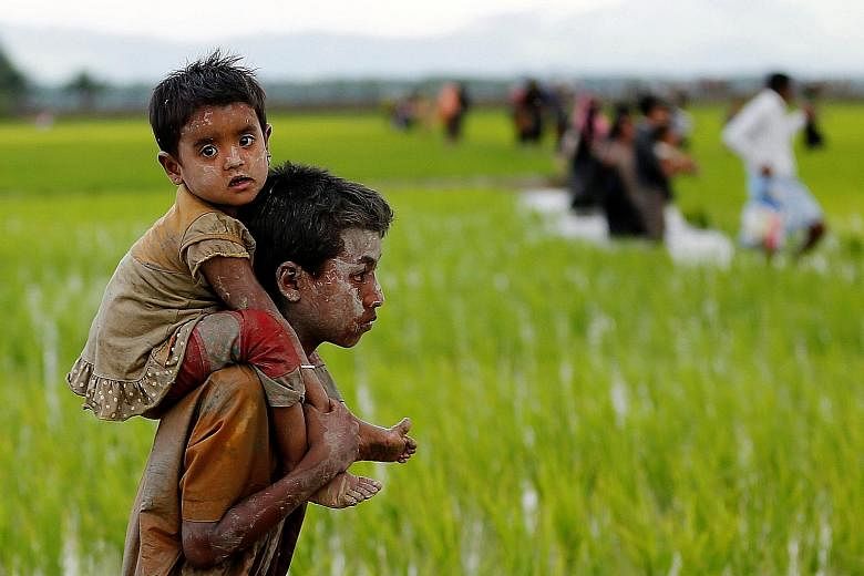 Rohingya children after crossing the border into Teknaf, Bangladesh, last Friday. The World Food Programme has suspended aid in Rakhine as the humanitarian situation has deteriorated.