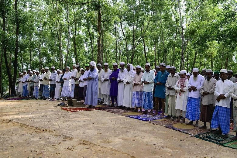 Rohingya refugees performing Eid prayers at Kutupalong refugee camp near the Bangladesh-Myanmar border yesterday. Rohingya fleeing to Bangladesh claim the Myanmar army is trying to force them out.