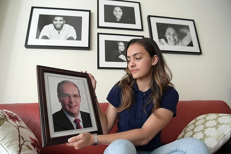 Amita Berthier, 16, won one of Singapore's two fencing gold medals at the SEA Games, a year after her dad Eric died. Amita holds a portrait of her father, who supported her in ways small and big. He was, among other things, her chief cheerleader, cha