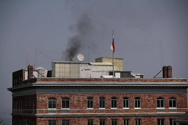 Black smoke billowing from a chimney on top of the Russian consulate in San Francisco, California, on Friday. A conspiracy theory suggests the Russians were burning documents ahead of a search of the building.