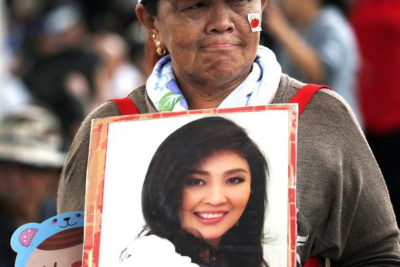 A supporter of Yingluck Shinawatra at the Supreme Court on Aug 25, where she failed to show up for the verdict reading.