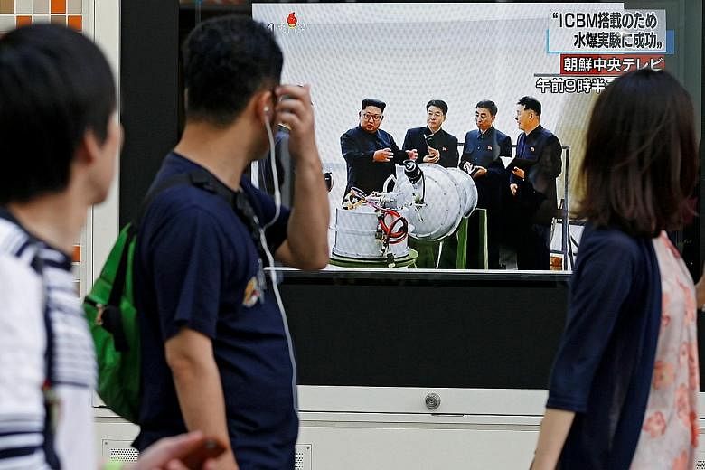 A street monitor in Tokyo, Japan, showing North Korean leader Kim Jong Un in a news report about his country's nuclear test yesterday. With the regime escalating tensions with the US, nervous investors are likely to sell risky investments and seek sa
