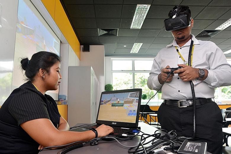 ITE College Central students Noor Rashikin Mohamed Rashid and Lesalan Bathmanathan demonstrating how they use virtual reality to step into different pre-school environments and learn to scan these places for signs of danger.