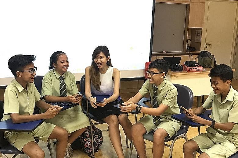Miss Mavis Ho facilitating a group discussion with her students, using the NewsEd app.