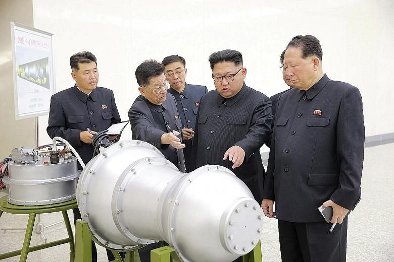 North Korean leader Kim Jong Un "giving guidance" on the nuclear weapons programme in this undated photo released by North Korea's Korean Central News Agency yesterday. Though he has been in power for nearly six years, Mr Kim remains something of an 