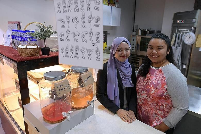 Miss Suzana Slemat (left), 19, and Miss Shazlina Sulaiman, 20, hope to raise awareness of the challenges of the deaf community in Singapore through their cafe.