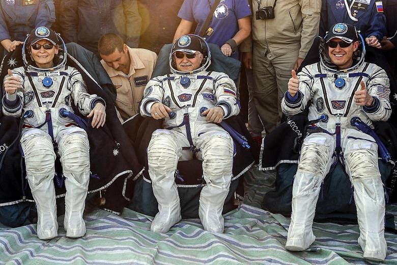 Biochemist Peggy Whitson and her crew mates, Russian space agency Roscosmos' Fyodor Yurchikhin (centre) and fellow Nasa astronaut Jack Fischer, resting shortly after landing the Soyuz MS-04 space capsule in Kazakhstan yesterday morning. Among her oth