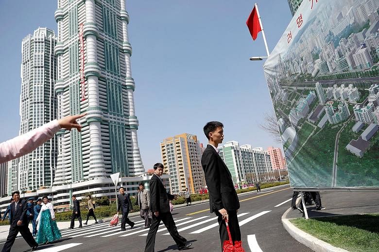 Visitors taking a tour of a new residential complex in Pyongyang in April. New housing in high-rises is generally assigned by profession.