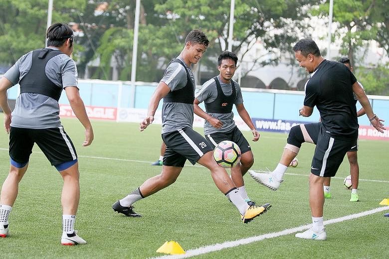 National head coach of youth Fandi Ahmad enjoying training at Jalan Besar with (from left) Ho Wai Loon, Irfan Fandi and Izzdin Shafiq. The Lions are bottom of their Asian Cup qualifying group and badly need a win.