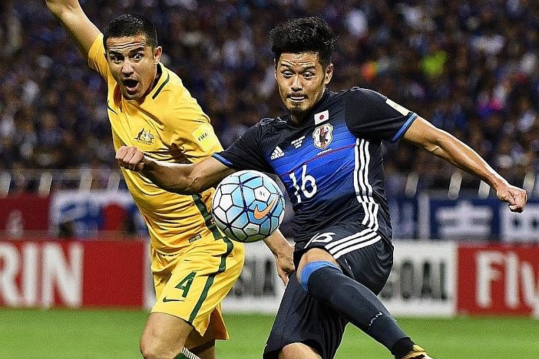 Tim Cahill, Australia's top scorer with 48 goals, tussling for the ball with Hotaru Yamaguchi of Japan during last Thursday's World Cup qualifier in Saitama, where the home side won 2-0. Cahill has promised that his side will perform "fearlessly" aga