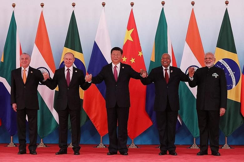 (From left) Brazilian President Michel Temer, Russian President Vladimir Putin, Chinese President Xi Jinping, South African President Jacob Zuma and Indian Prime Minister Narendra Modi at the summit in Xiamen yesterday. Mr Xi said Brics should jointl