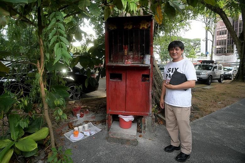Mr Charles Goh with the shrine erected in honour of Madam Huang Su Ying. It now needs to be removed due to redevelopment works.