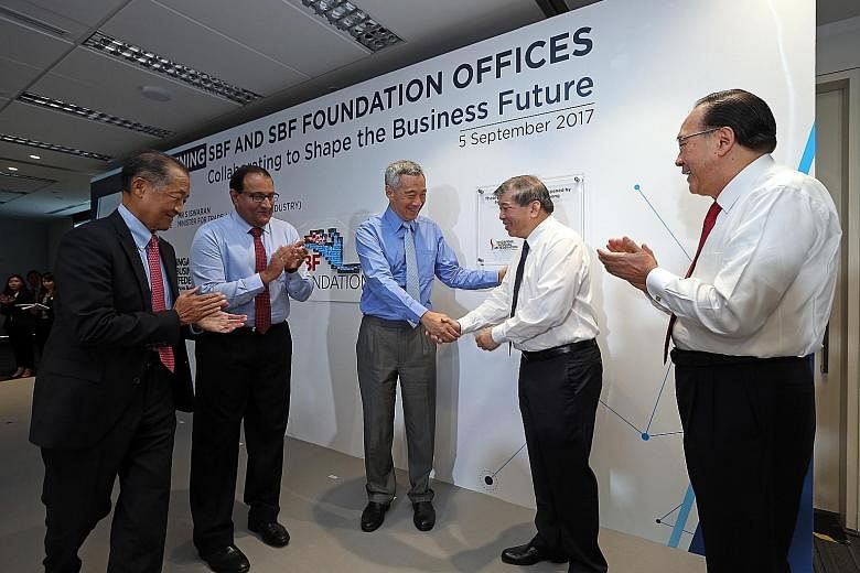 (From left) Past SBF chairman Stephen Lee, Minister for Trade and Industry (Industry) S. Iswaran, Prime Minister Lee Hsien Loong, SBF chairman Teo Siong Seng and past SBF chairman Tony Chew at the official opening of SBF Centre in Robinson Road yeste