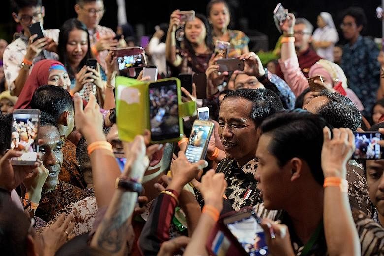 Indonesian President Joko Widodo greeting the crowd at the Indonesian Embassy in Chatsworth Road yesterday. Many queued for hours to catch a glimpse of Mr Joko, who will attend a Leaders' Retreat with Prime Minister Lee Hsien Loong today, as Singapor