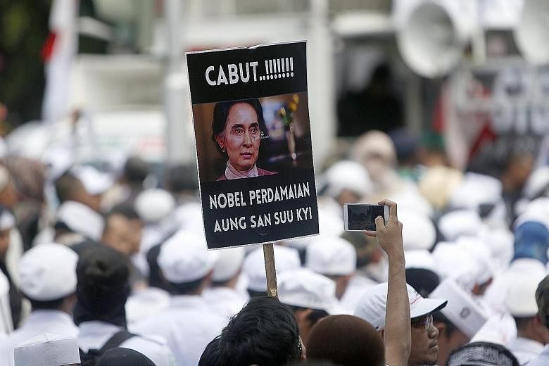 A protester with a placard that reads "Pull out the Nobel Peace Prize" awarded to Ms Aung San Suu Kyi during a rally against the persecution of the Rohingya in Jakarta yesterday.