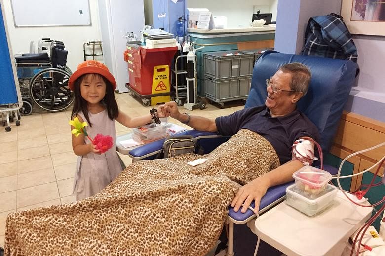 Left: Kesslyn Ng, a K1 pupil from Good Shepherd Convent Kindergarten, with dialysis patient Chin Ah Kiff at a National Kidney Foundation dialysis centre in Bedok last month. K1 pupils had visited the centre several times, preparing and presenting cra