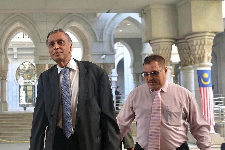 Mr Nor Mohamed Yakcop (left) arriving yesterday to testify at the ongoing Royal Commission of Inquiry (RCI). His testimony was much anticipated as he is seen as a former insider who might name names and unveil more details on the trading losses, said