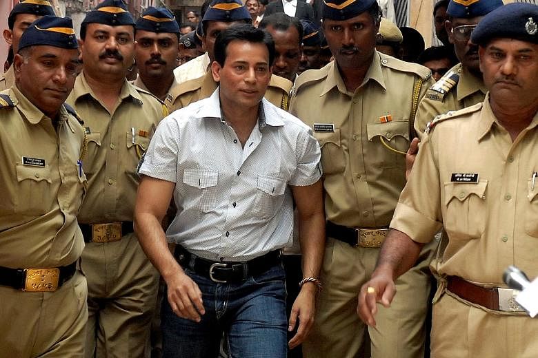 A 2007 picture of Abu Salem arriving at a court in the southern city of Hyderabad. He was sentenced to life imprisonment yesterday instead of the death penalty as that was the condition set by a Lisbon court before it allowed his extradition from Por
