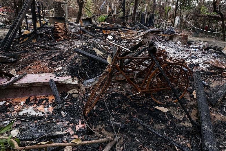 Top: The remains of houses burned allegedly by Rohingya militants in Maungdaw township, Rakhine state, as seen on Wednesday. Above: Rohingya insurgent leader Ata Ullah in a Skype interview with Reuters in Yangon in March.
