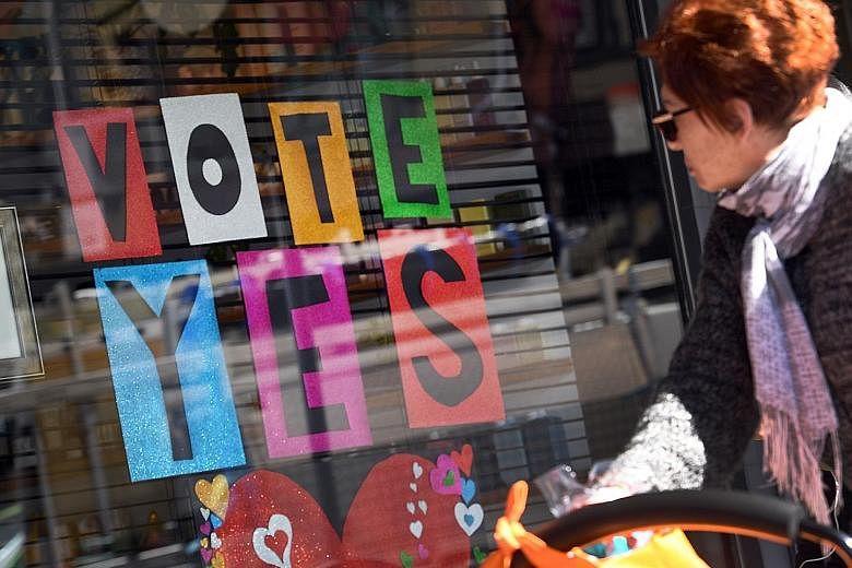 A sign in a shop window supporting same-sex marriage in Sydney. Australians will begin voting in the non-compulsory ballot as early as next week, with a result expected some time in November.