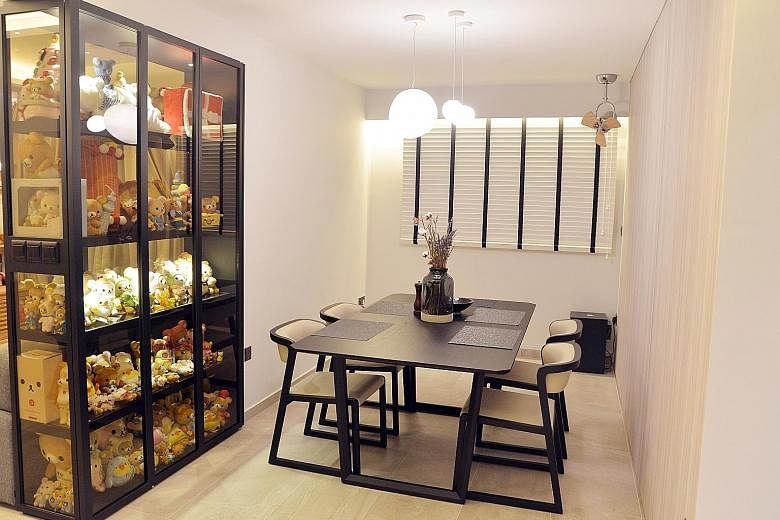 A tinted glass cabinet with black leather laminates not only showcases Mrs Sarah Lim's teddy bear collection, it also acts as a divider between the living and dining areas. The master bathroom has a rain shower with an LED ring light installed as the