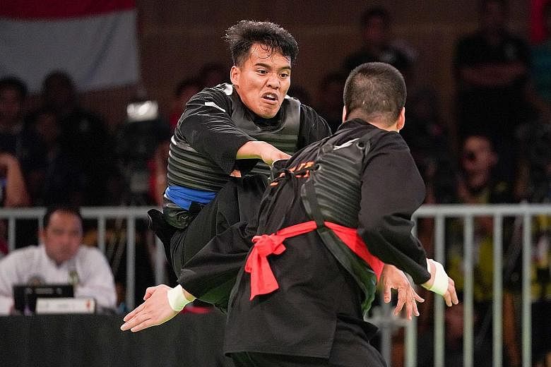 Singapore's Shakir Juanda (in blue) attacking his Vietnamese opponent in the SEA Games final last month. He lost 0-5 but, more than that, suffered a lateral collateral ligament tear in his right knee.