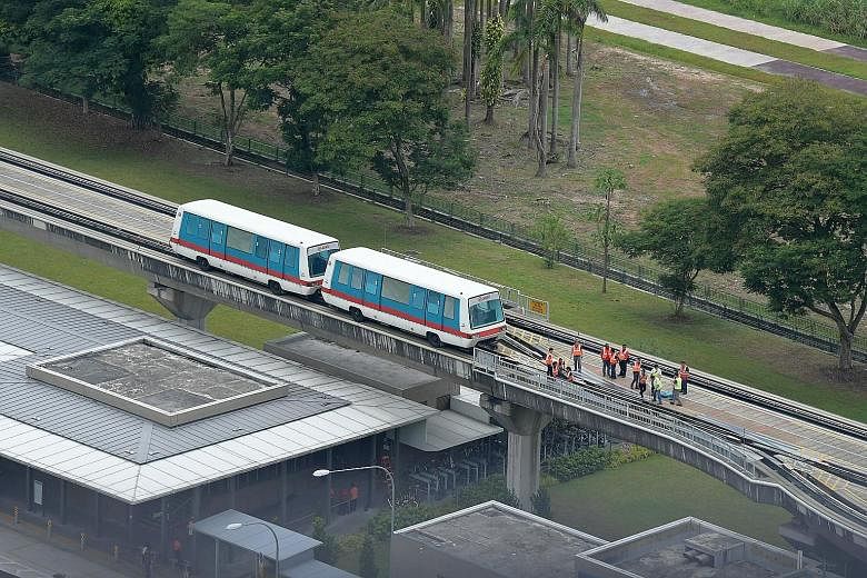 Above: The second LRT train stalled between Phoenix and Bukit Panjang stations and could not continue service. About 10 passengers were guided to Bukit Panjang station on foot. Left: Commuters were kept updated on the disruption via signs, on Twitter