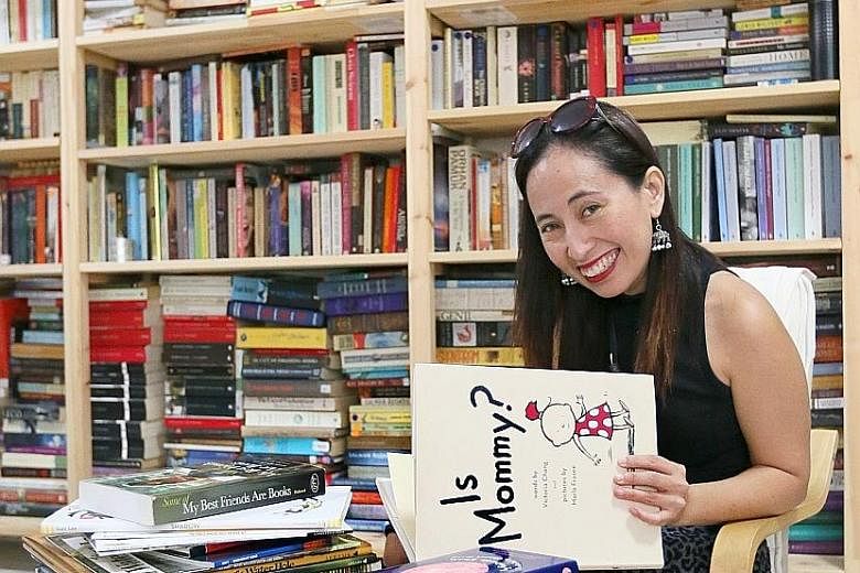 Assistant Professor Myra Garces-Bacsal with her collection of picture books at the National Institute of Education.