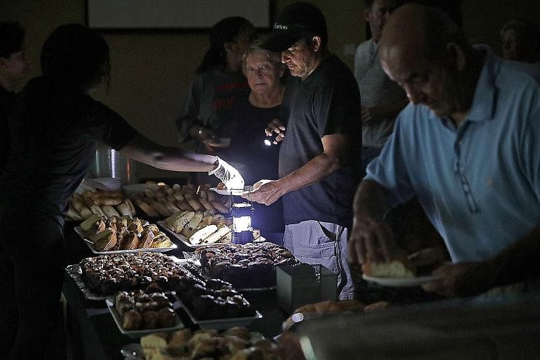 Hotel guests being served breakfast by lamplight as the power remained off at the Marriott. The aftermath of Hurricane Irma as seen from the air over the Florida Keys. Officials warned that it would take a long time to repair the damage wrought by hi