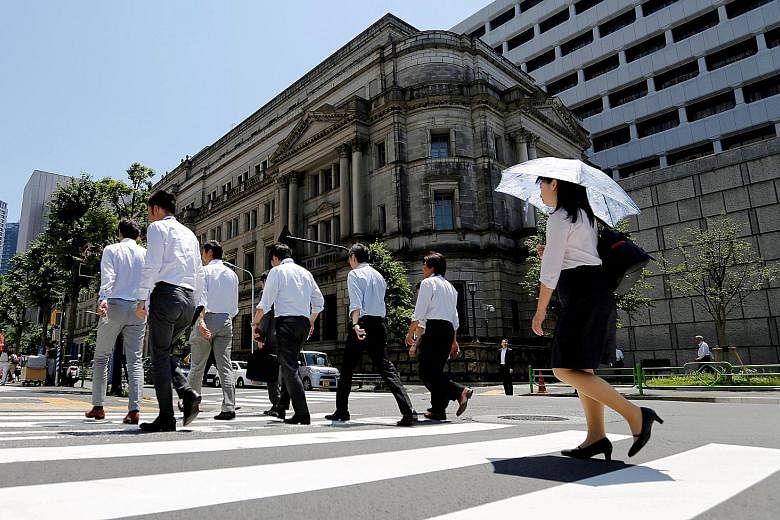The Bank of Japan building in Tokyo. With the BOJ committed to holding down the benchmark bond yield at around zero per cent, Japanese banks are following the nation's largest insurance firms in considering more alternative assets as choices narrow.